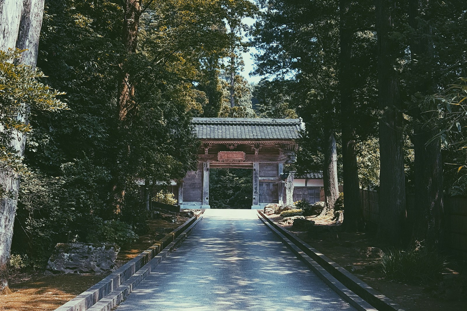 A long road with a gate in the middle of it